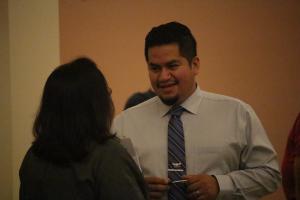 Man in tie holding pen discussing issues